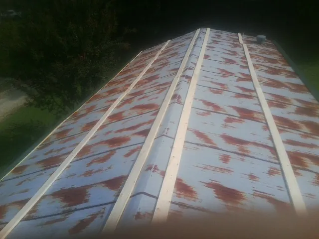 Rusted metal roof panels with new wood purlins before replacement — Storm Damage Roof Repair in Blue Bell by Roofing Brothers